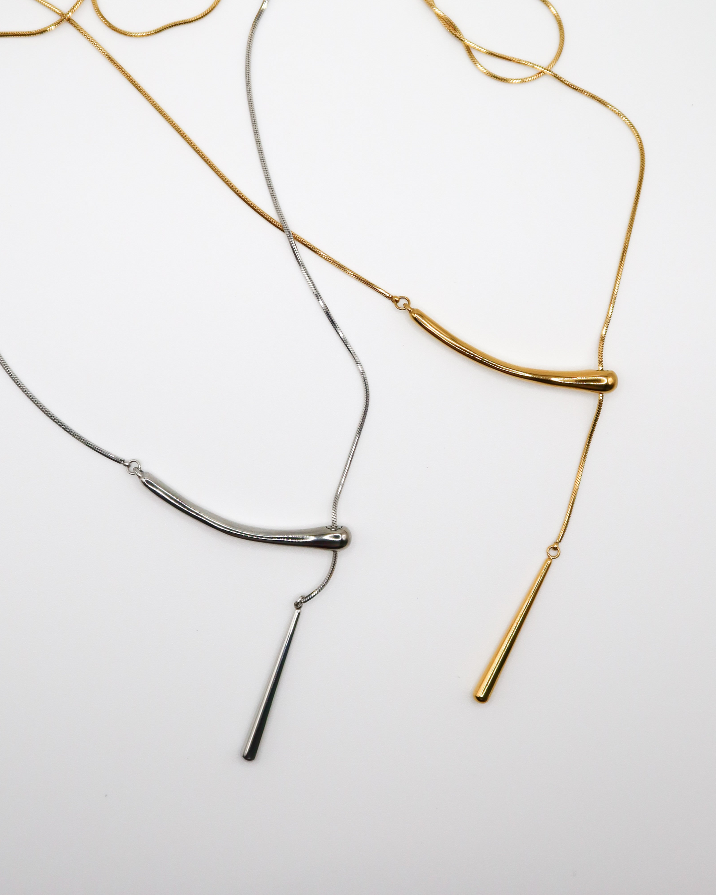 GOLD AND SILVER PENDANT CHAIN NECKLACE ON WHITE BACKGROUND