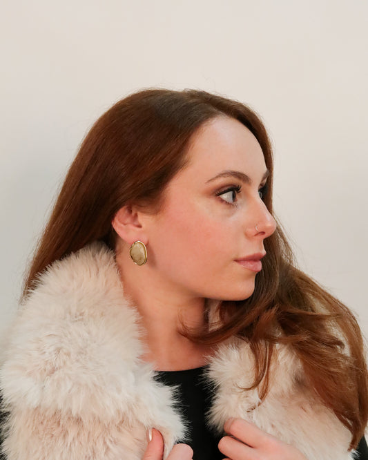 Woman wearing a white fur stole with a plain background