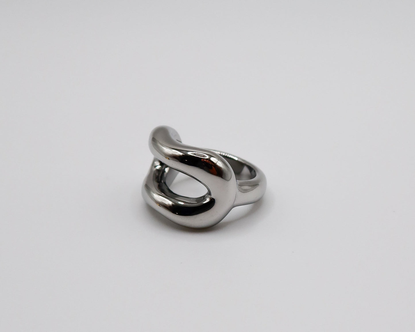 Silver ring on a light gray background