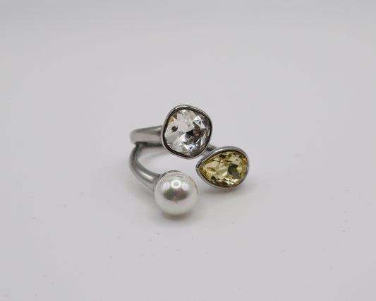 Three rings with different gemstones on a light gray background