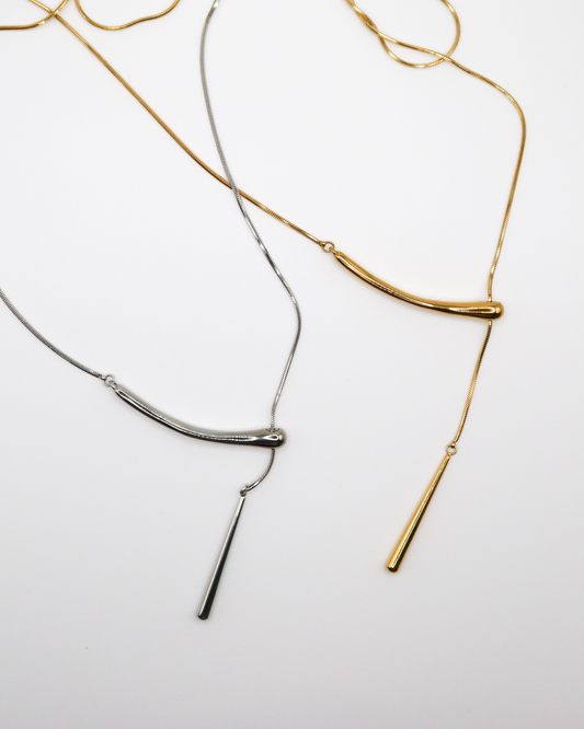 GOLD AND SILVER PENDANT CHAIN NECKLACE ON WHITE BACKGROUND