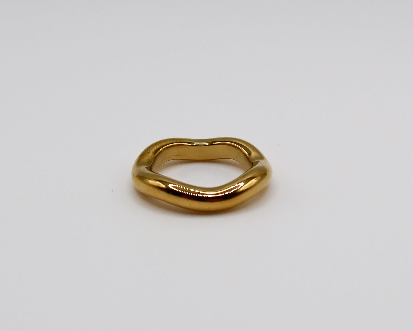 Gold ring on a light gray background