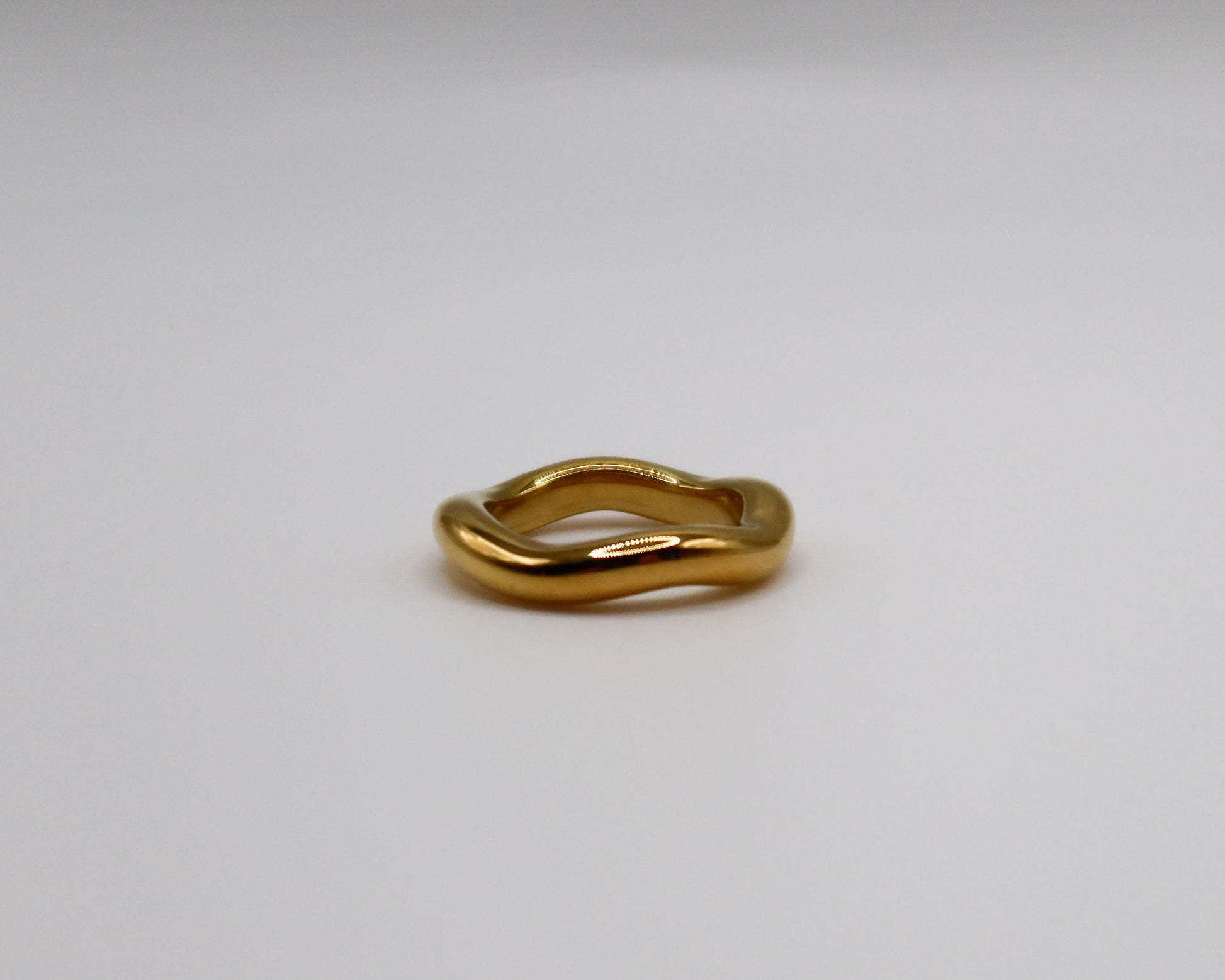 Gold ring on a light gray background
