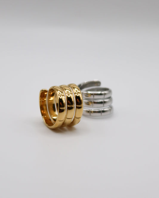 Gold and silver rings on a light gray background