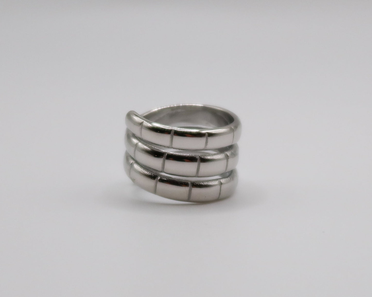 Silver ring with multiple bands on a white background