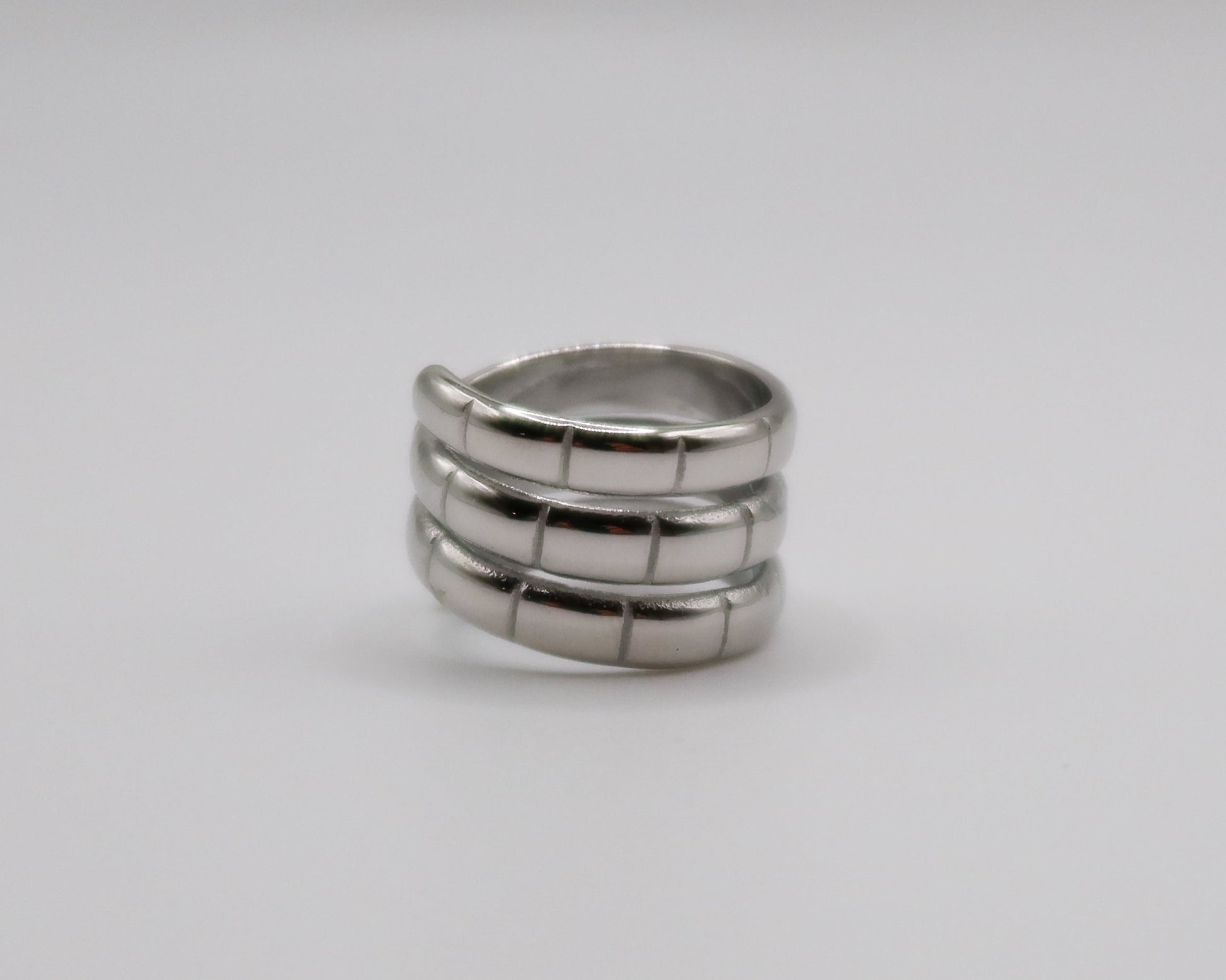 Silver ring with multiple bands on a white background