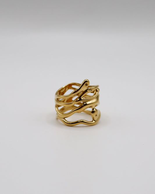 Gold ring on a light gray background