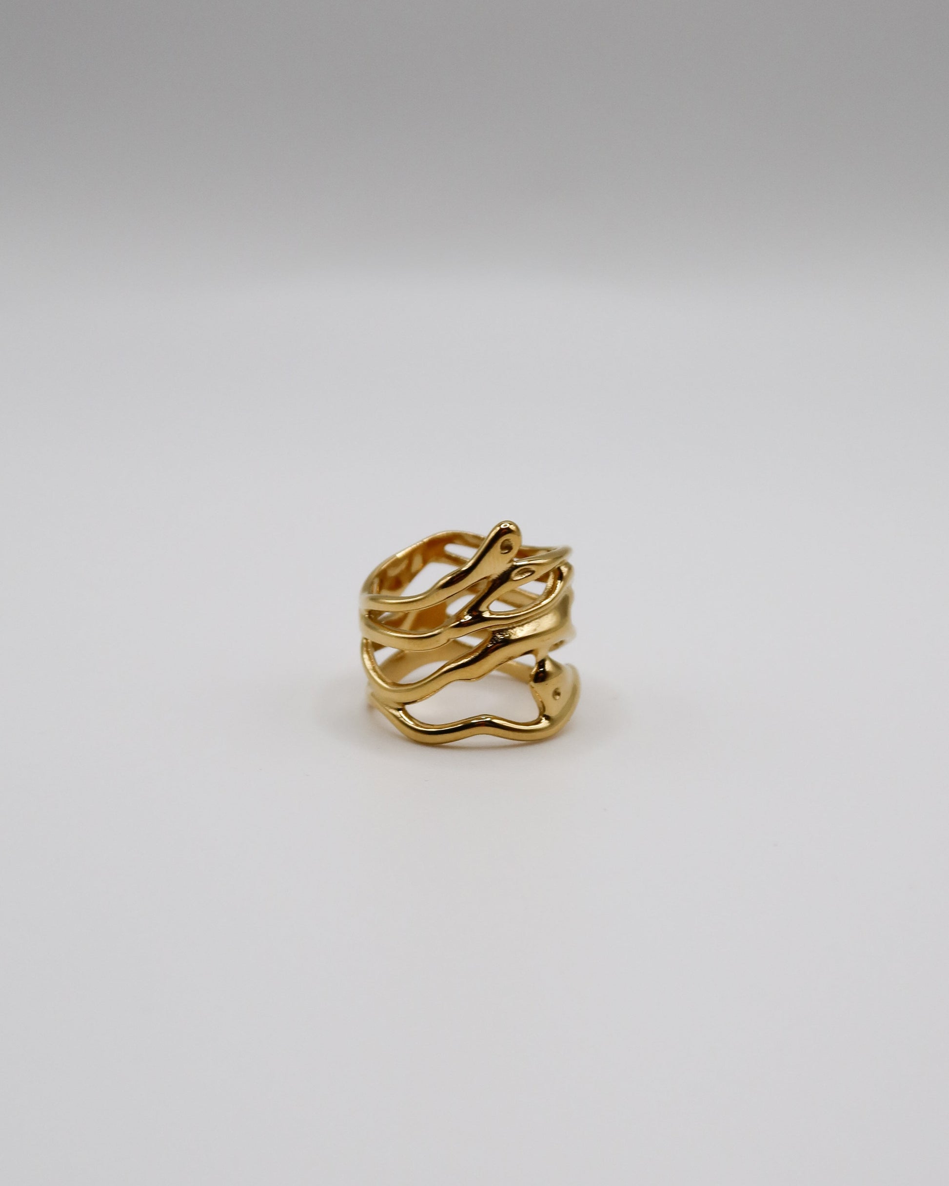 Gold ring on a light gray background