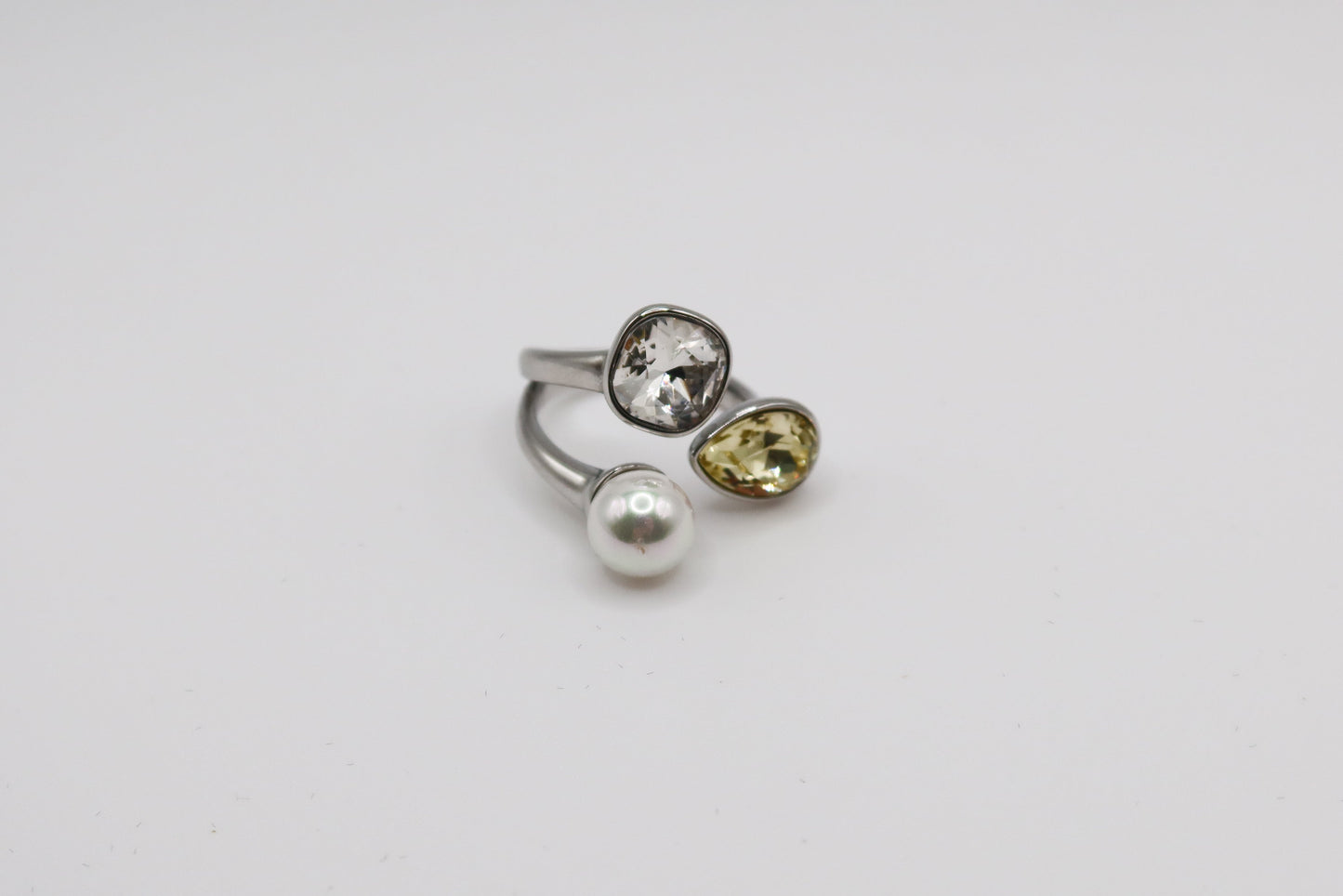 Three gemstone rings with different colored stones on a white background
