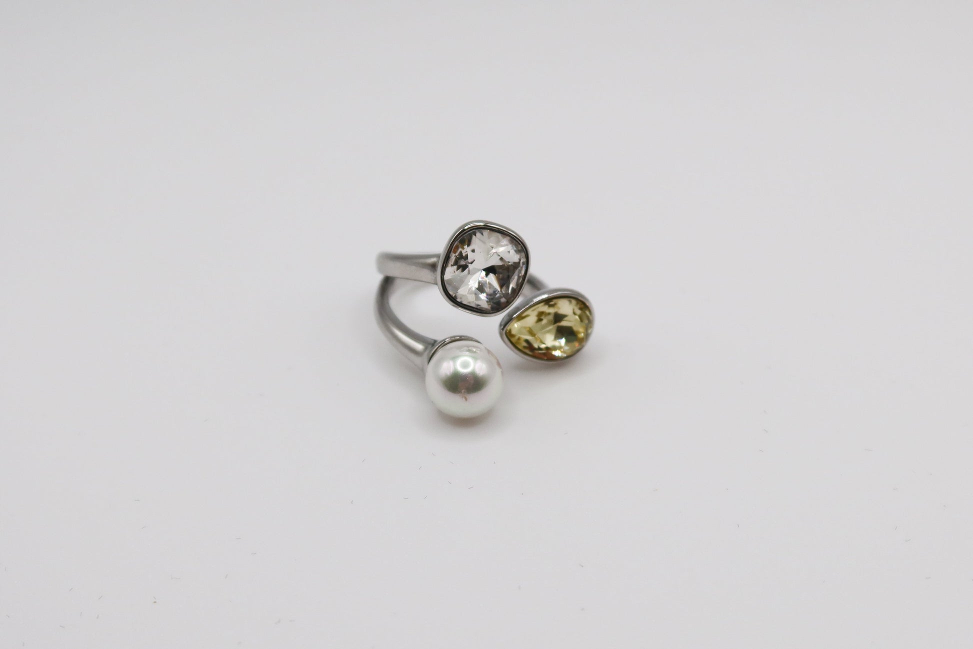 Three gemstone rings with different colored stones on a white background
