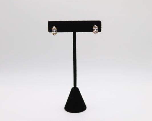 Black earring stand with two earrings on a white background